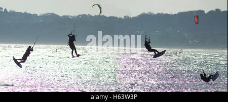 Flying kite-surfer in Swansea Bay, October 2016. Four images from take-off to landing merged. Stock Photo