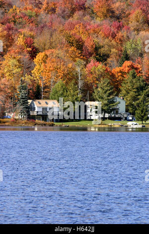 Houses by the lake in Upstate New York, in autumn, with trees changing colors Stock Photo