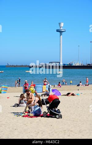 Holidaymakers on the beach with the Jurassic Skyline tower to the rear, Weymouth, Dorset, England, UK, Western Europe.