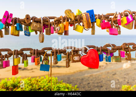 Padlocks of love on rusty chain seaview Stock Photo