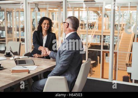 Making a deal in the office boardroom Stock Photo