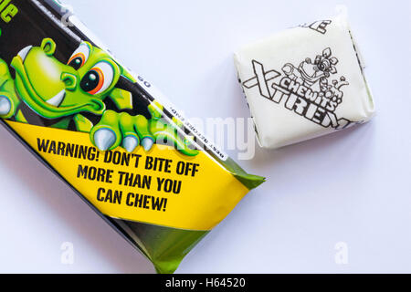 Warning don't bite off more than you can chew - detail on pack of Xtreme Chewits extremely sour apple with one removed Stock Photo