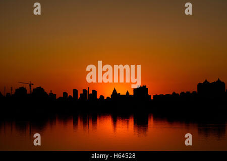 Silhouette of Buildings at sunset time in metro city. Conceptual and idea image. Stock Photo