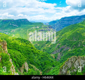 The deep winding Vorotan river canyon with massive rocks, covered with greenery, Tatev, Syunik Province, Armenia. Stock Photo