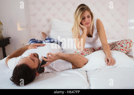 Disappointed wife not getting attention from husband Stock Photo