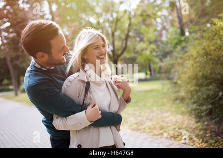 Loving happy couple walking in park Stock Photo