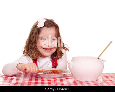 happy little girl eat tomato soup Stock Photo