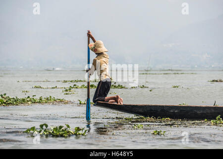 Local fishermen rowing from knees on fishing boat, Inle Lake, Shan State, Myanmar Stock Photo