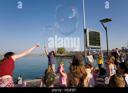 Street artist making large soap bubbles, children, show, port, Konstanz, Baden-Wuerttemberg Stock Photo