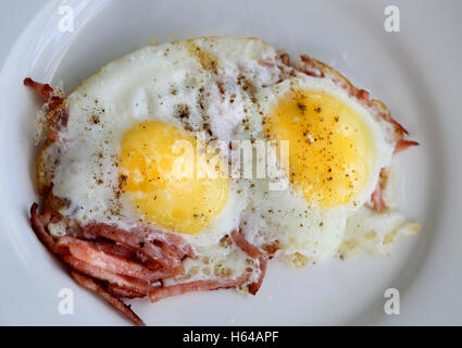Scrambled eggs on a plate with sausage photographed in close-up Stock Photo