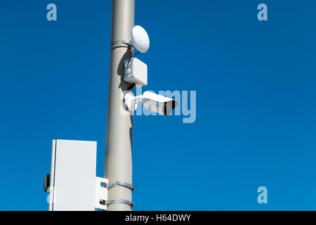 security cameras on street pylon with blue sky Stock Photo