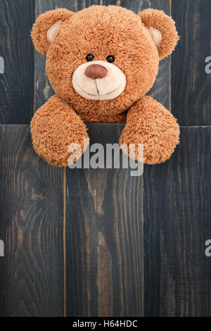 Cute teddy bear with old wood background Stock Photo