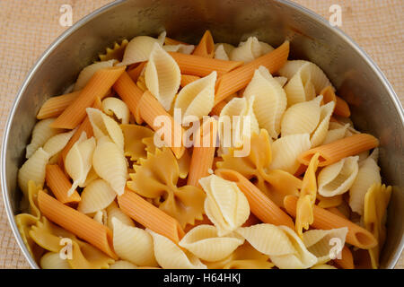 Variety of cooked pasta in stainless steel bowl Stock Photo