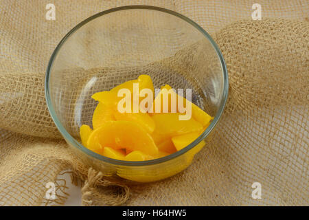 Canned sliced peaches in glass bowl Stock Photo