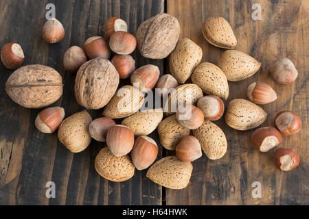 Walnuts, Hazelnuts and Almonds on a Rustic Wooden Table. Stock Photo