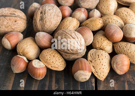 Walnuts, Hazelnuts and Almonds on a Rustic Wooden Table. Stock Photo