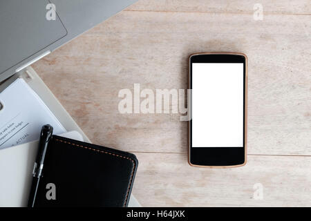 top view smartphone with blank screen on wood desk Stock Photo