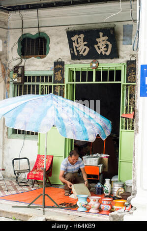 Laying out items for sale on private house veranda, Lorong Stewart, Georgetown, Penang, Malaysia Stock Photo