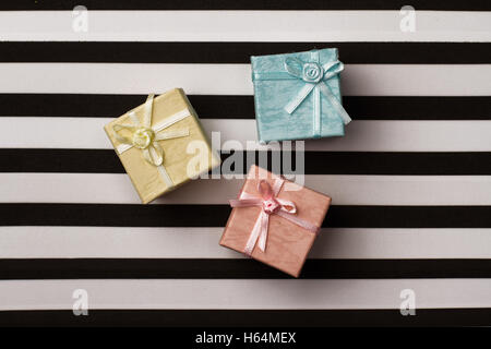 top view of colored gift boxes on black and white stripes background Stock Photo