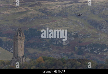 A helicopter with the Duke of Cambridge, known as the Earl of Strathearn in Scotland, onboard flies past the Wallace Monument after he left the Argyll and Sutherland Highlanders Regimental Museum at Stirling Castle after a visit. Stock Photo