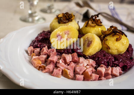 Traditional czech cuisine dumpling with smoked meat and onion Stock Photo