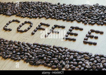 Word coffee made from coffee beans with borders. Selective focus, diagonal side-view Stock Photo