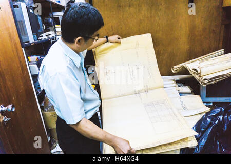 Senior man working on his building project at room site construction work. Stock Photo