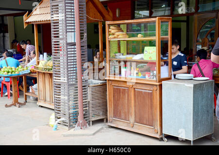 Laotian people cooking Khao Jee Sandwich or Baguette Sandwich is a famous street food for sale in morning at local restaurant on Stock Photo