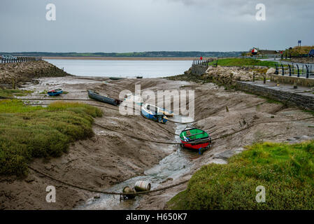 Boats sitting on the riverbed at Greenfield Dock, North Wales, UK. The dock leads into the River Dee estuary. Picture credit: Brian Hickey/Alamy Stock Photo