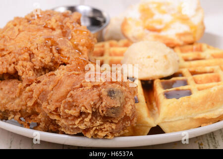 Closeup of Chicken and Waffles with honey, maple butter and maple syrup Stock Photo