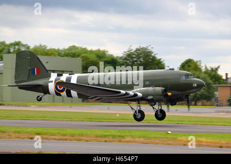 Douglas C-47A Skytrain, military version of the DC-3 Dakota,in USAAF D-Day markings at Biggin Hill Air Show, Bromley, UK Stock Photo