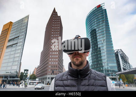 Man wearing Virtual Reality (VR) goggles at Potsdamer Platz in Berlin, Germany Stock Photo