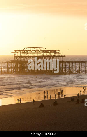 Sunset over the ruined West Pier, Brighton beach, Brighton, East Sussex England UK Stock Photo