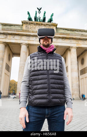Man wearing Virtual Reality (VR) goggles in front of Brandenburg Gate  in Berlin, Germany Stock Photo