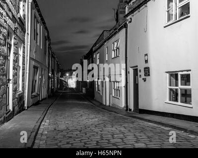 Henrietta street in Whitby North Yorkshire looking fro the Smoke house towards the 199 Steps in Monochrome Stock Photo