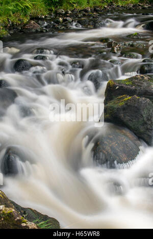 Detail of water flowing over boulders in the River Garry in Glengarry Forest, Lochaber, Scottish Highlands, Scotland Stock Photo