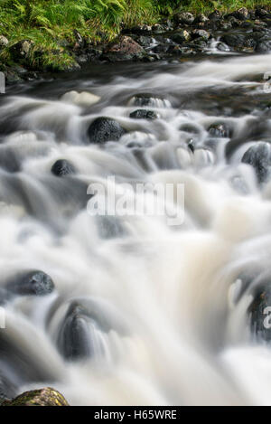 Detail of water flowing over boulders in the River Garry in Glengarry Forest, Lochaber, Scottish Highlands, Scotland Stock Photo