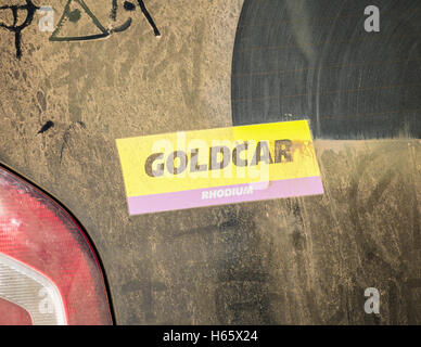 Goldcar rental car with dirty rear window. Spain Stock Photo
