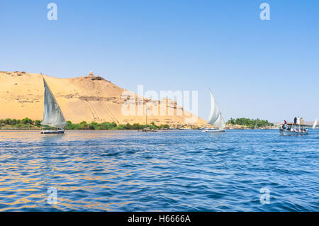 Feluccas are very popular among the tourists, who enjoys the pleasant trips in Aswan, Egypt. Stock Photo