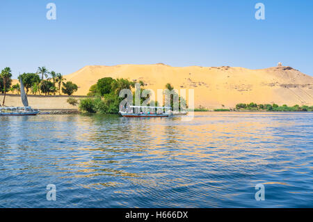 The boat and felucca trips are very popular in Aswan, the main landmarks located on the different Nile banks and islands, Egypt. Stock Photo