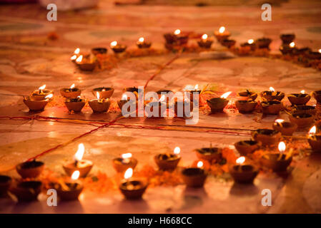 Lit up oil lamps glowing during festival of Diwali in India. Stock Photo
