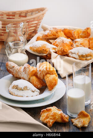 Sweet pies, jug and glasses with milk in style a rustic Stock Photo