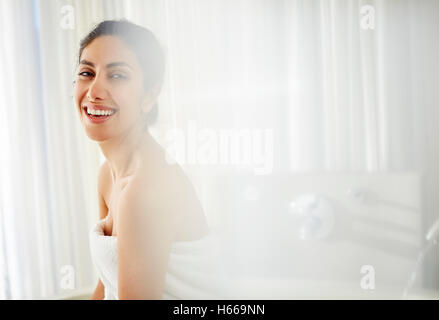 Portrait smiling woman wrapped in towel Stock Photo