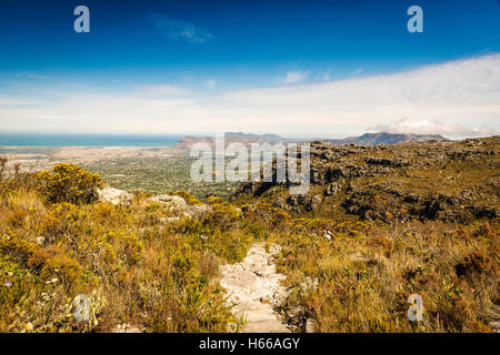 Hiker on Table Mountain track with Cape Town in the background Stock Photo