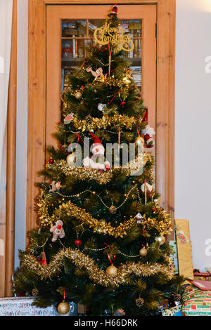 A decorated Christmas tree with presents beneath it Stock Photo