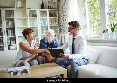 Financial advisor shaking hands with senior woman Stock Photo