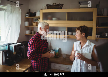 Senior couple interacting while having coffee Stock Photo