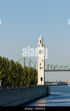 The Clock Tower located on Quai de Horloge with the Jacques Cartier Bridge in back, Old Port of Montreal, Quebec, Canada Stock Photo