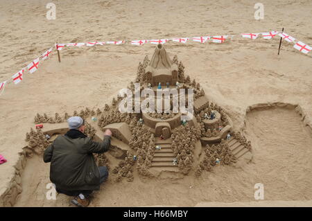 A sculptor creates a fantasy castle on the beach, of London's river Thames. Stock Photo