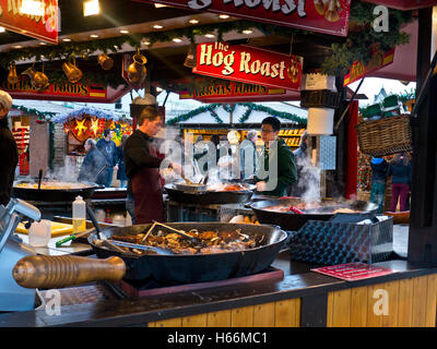 ALFRESCO CHRISTMAS HOT WINTER FOOD STALL MARKET South Bank German Christmas market takeaway hog roast food stall and visitors London UK Stock Photo